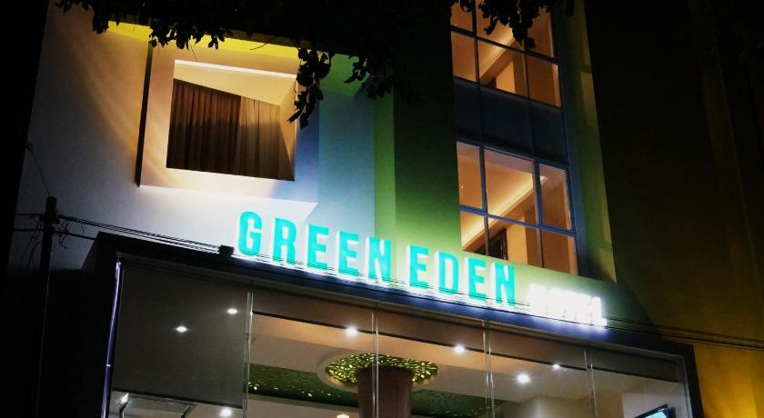 a neon sign on the side of a building, Green Eden Hotel in Manado