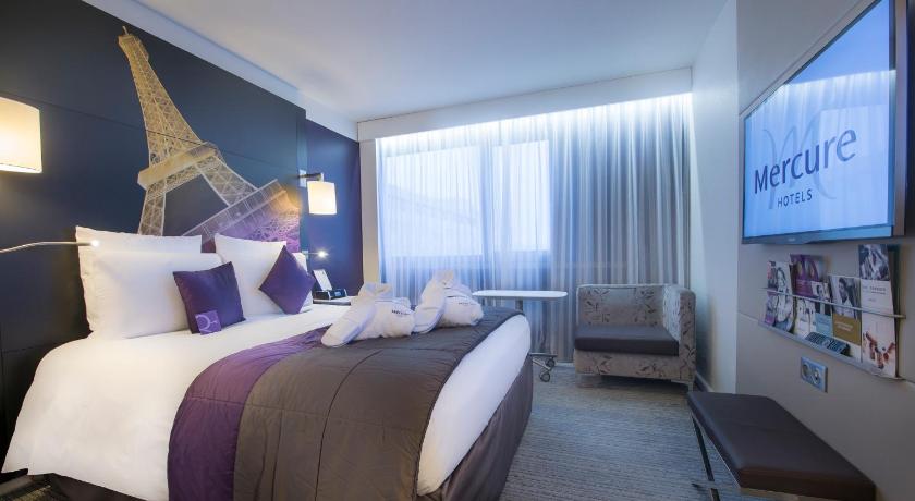 a bedroom with a large bed and a large window, Mercure Paris Centre Tour Eiffel in Paris
