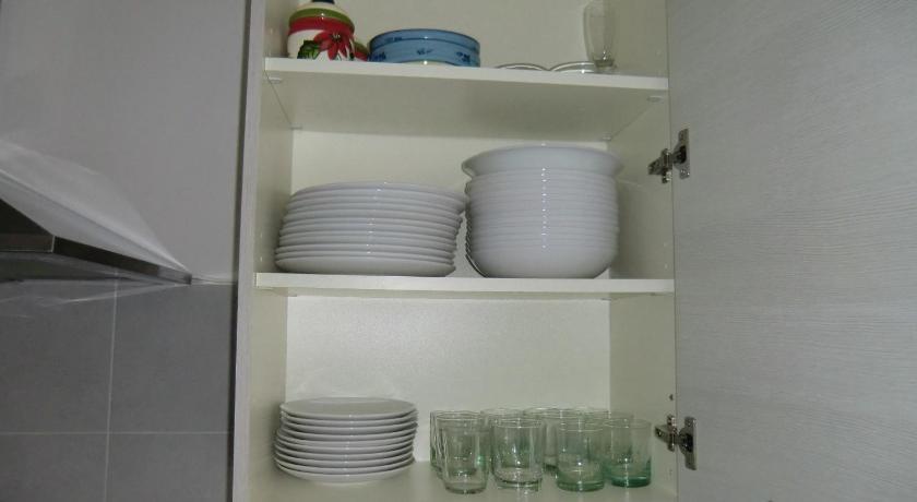 a white bowl filled with dishes on top of a white counter, Residence Daytona in Caorle