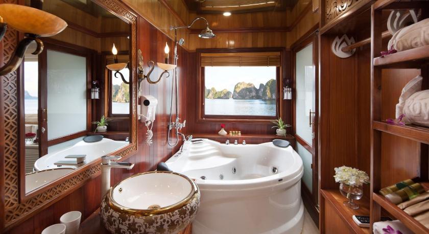 a bathroom with a sink, toilet and bathtub, La Regina Royal Cruise in Hạ Long
