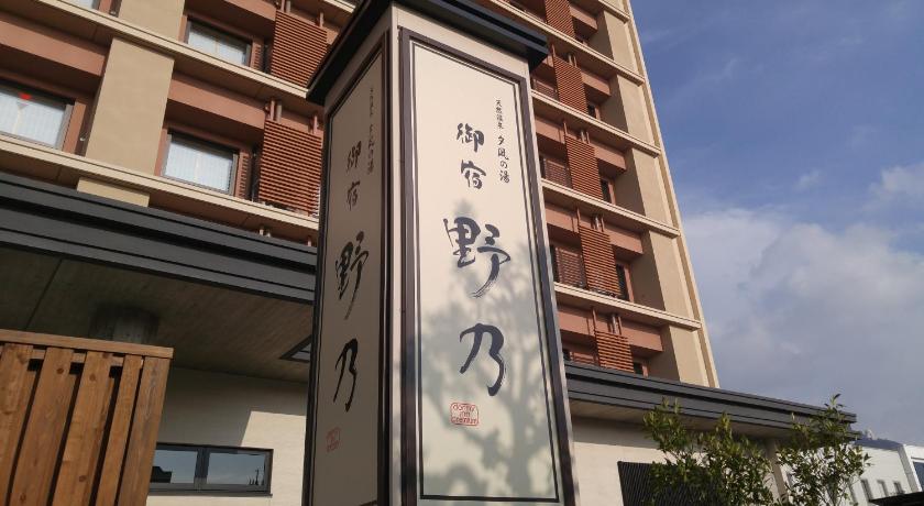 a street sign on a pole in front of a building, Sakaiminato Onyado Nono Natural Hot Spring in Yonago