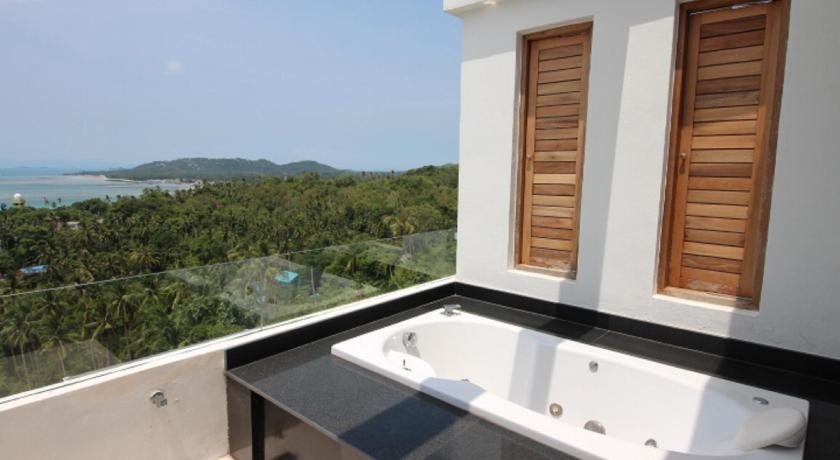 a large white bath tub sitting next to a beach, Tropical Sea View Residence in Koh Samui