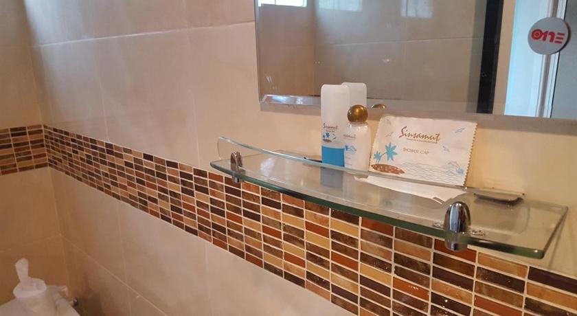 a bathroom with a sink, toilet, and mirror, Sinsamut Hotel Koh Samed in Ko Samet