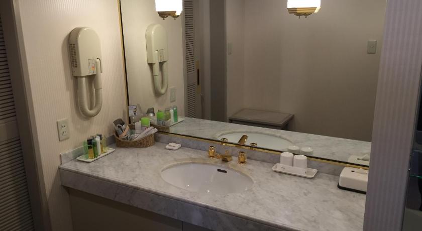 a bathroom with a sink, mirror, and soap dispenser, Hotel New Omi in Omihachiman