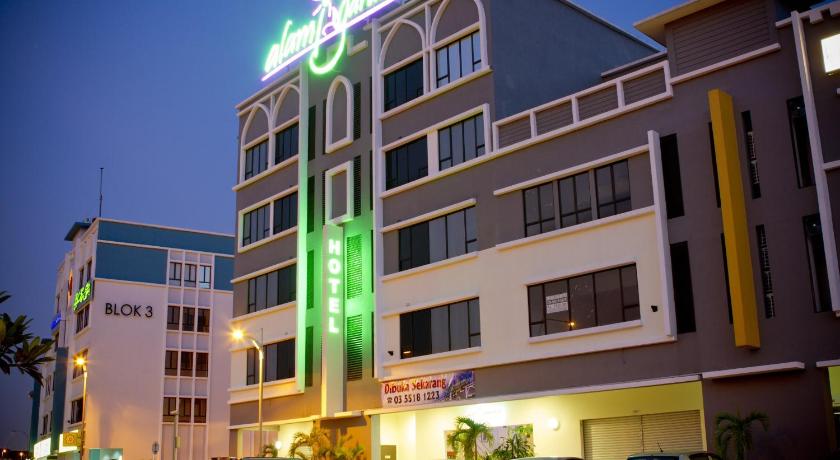 a large building with a neon sign on top of it, Alami Garden Hotel in Shah Alam