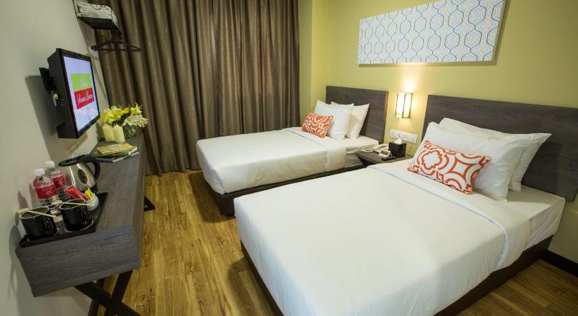 a hotel room with two beds and two lamps, Humaira Hotel in Tanah Merah