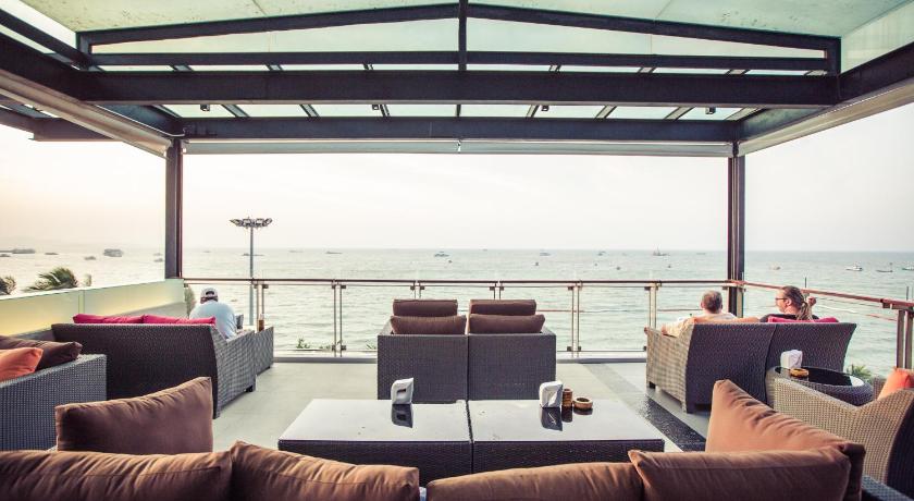 a living room filled with furniture and a balcony, Serenotel Pattaya in Pattaya