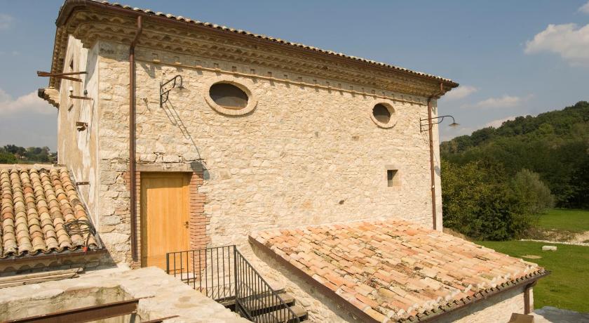 an old brick building with a clock on it, Albergo Diffuso La Piana dei Mulini in Colle d' Anchise