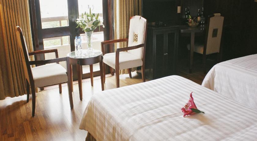 a hotel room with two beds and a table, Jasmine Hotel in Hue