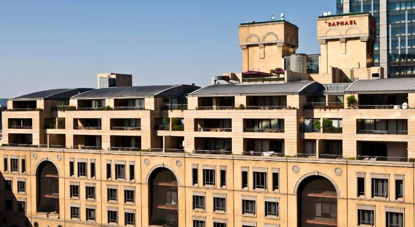 a large building with a large clock on the side of it, Raphael Penthouse Suites in Johannesburg