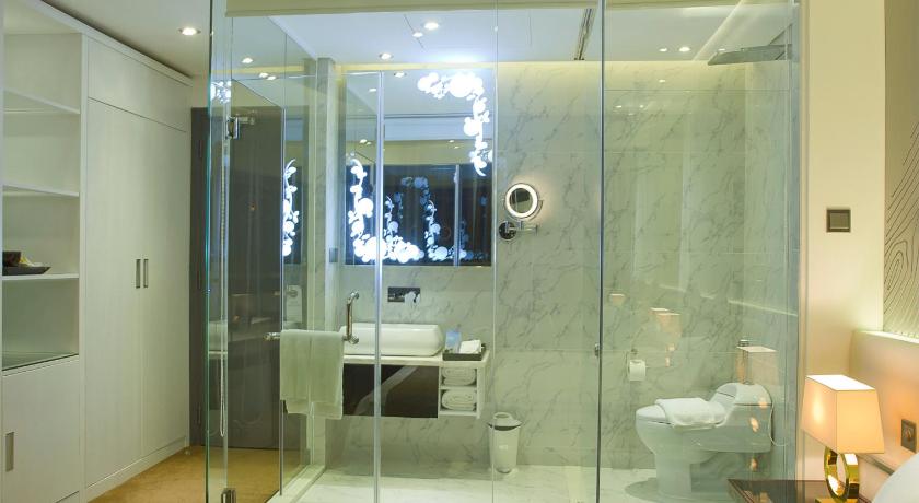 a bathroom with a glass shower stall and a toilet, Signature Boutique Hotel in Ho Chi Minh City