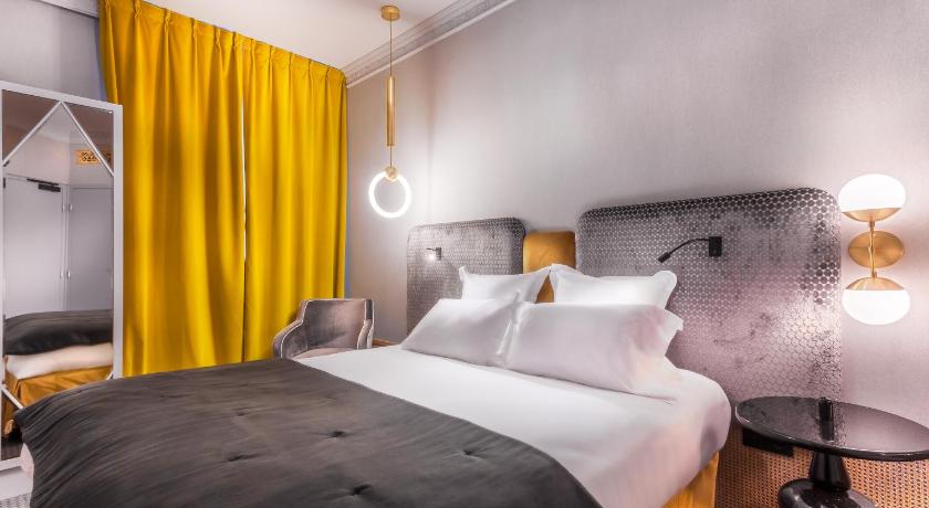 a bedroom with a large bed and a large window, Handsome Hotel by Elegancia in Paris