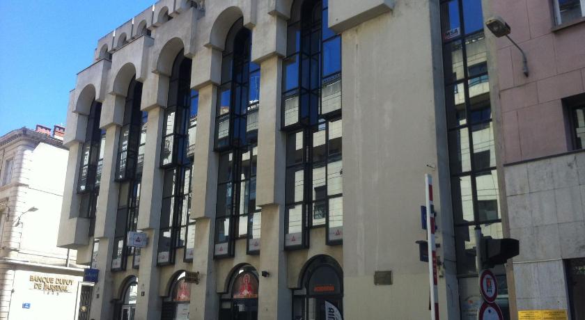 a large building with a clock on the side of it, Coeur Urbain Apartments - Place de la Comedie in Montpellier