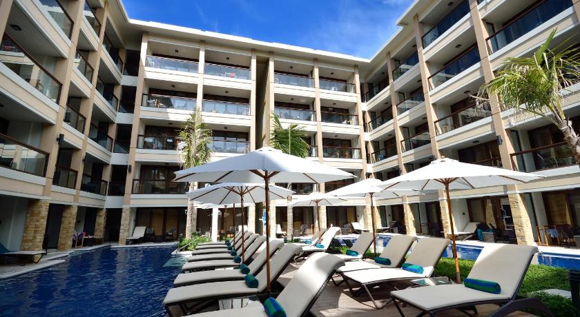 a patio area with tables and chairs and umbrellas, Henann Lagoon Resort in Boracay Island