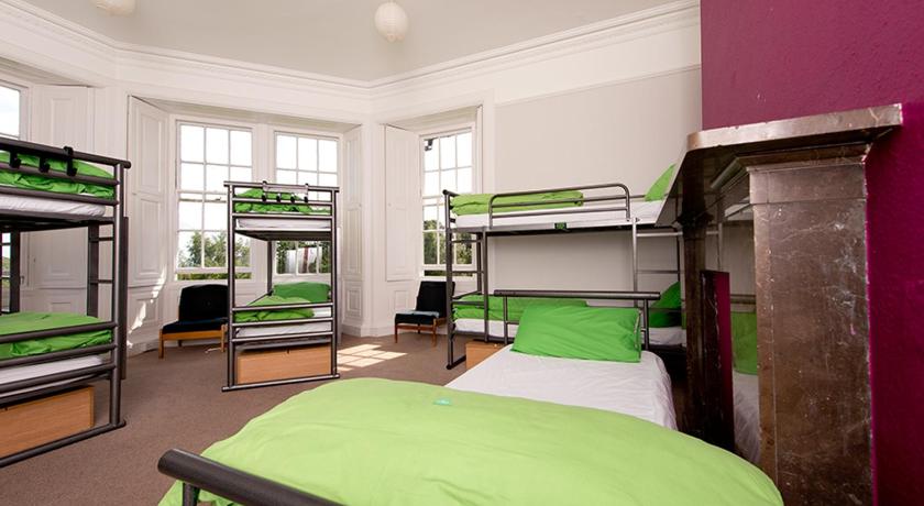 a bedroom with two bunk beds and a large window, YHA Langdale in Ambleside