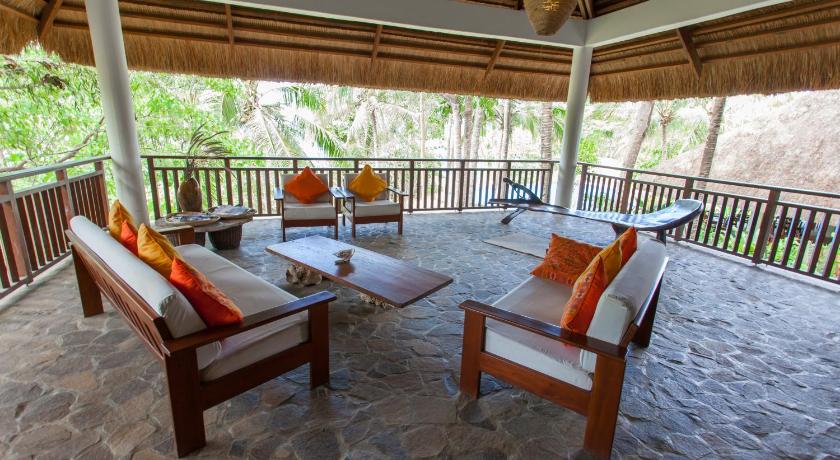 a living room filled with furniture and a patio, Amun Ini Beach Resort & Spa in Bohol