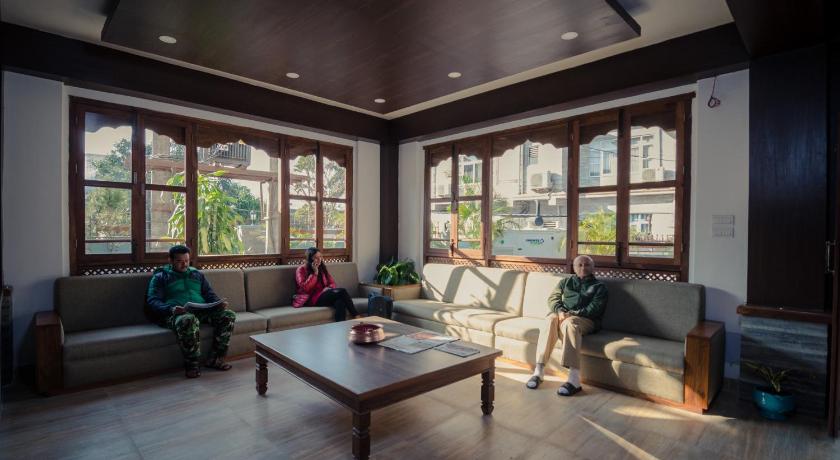 a living room filled with furniture and a window, Mount View Pokhara Hotel in Pokhara