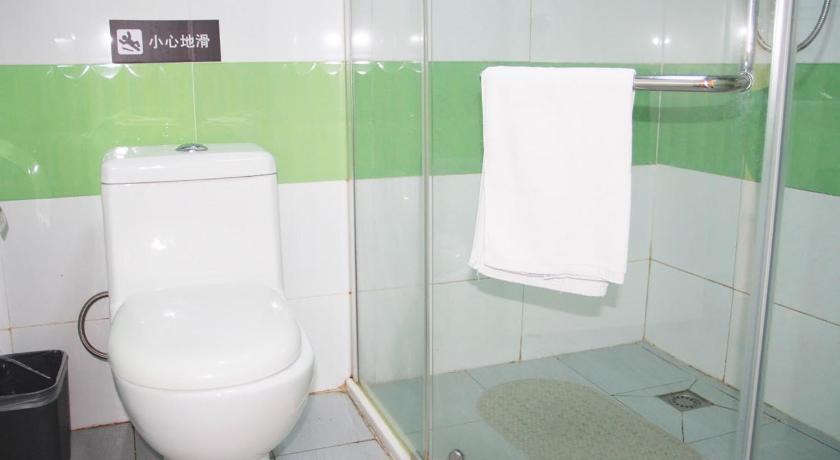 a white toilet sitting in a bathroom next to a shower, 7Days Inn Beijing Miyun Gulou Street County Government in Beijing