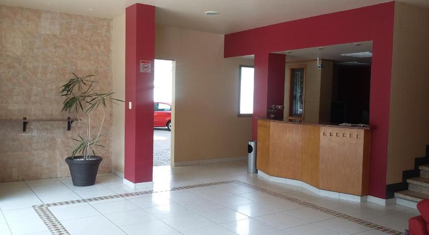 a room with a red wall and a blue floor, Hotel Virginia in Oaxaca