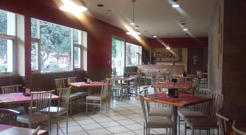 a restaurant with tables, chairs, and tables in it, Hotel Virginia in Oaxaca