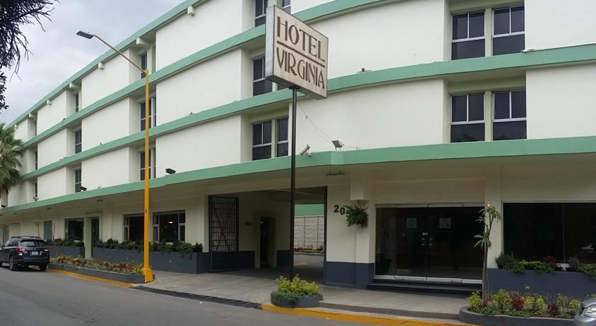 a large building with a parking meter on the side of the street, Hotel Virginia in Oaxaca