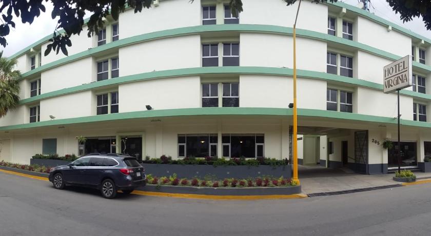 a white car parked in front of a building, Hotel Virginia in Oaxaca