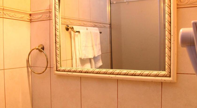 a bathroom with a mirror, sink, and toilet, Spon Boutique Hotel in Nafpaktos