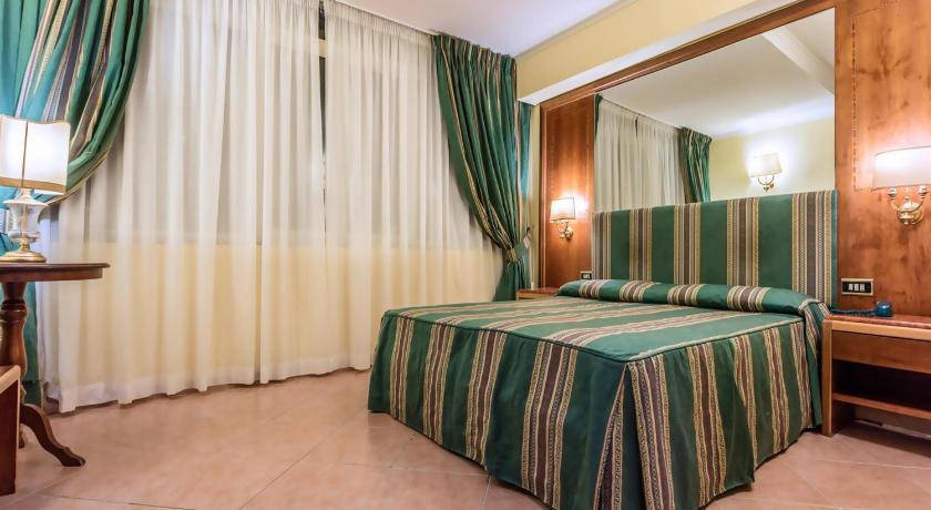 a hotel room with a large bed and a large window, Raeli Hotel Archimede in Rome