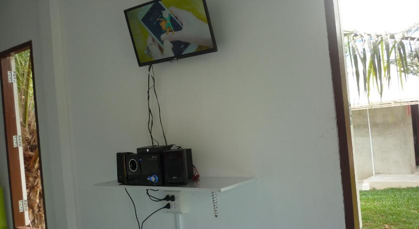 a television mounted on a wall next to a window, Maneemudjalin Resorts Farm Stay in Prachuap Khiri Khan