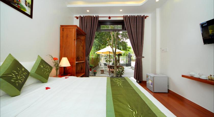 a bedroom with a large bed and a large window, Blue Lake Homestay in Hoi An