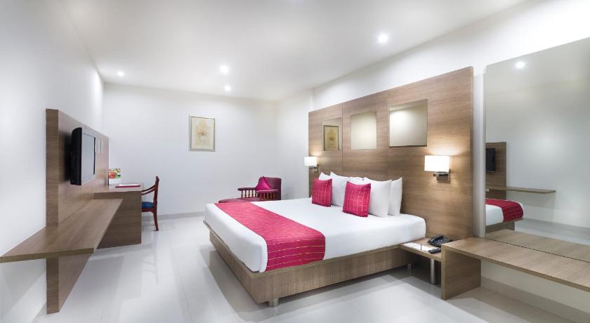a hotel room with two beds and two lamps, Regency Tiruttani by GRT Hotels in Tiruttani