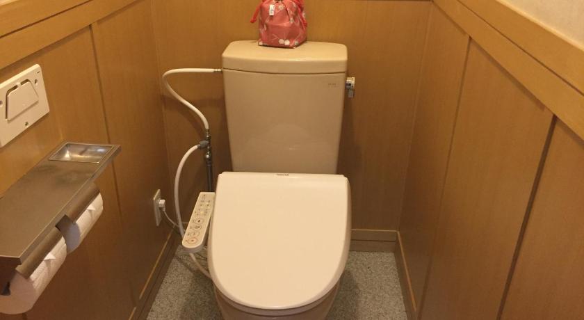 a small bathroom with a toilet and a sink, Ryokan Umibe no Kakure yu Seiryu in Izu