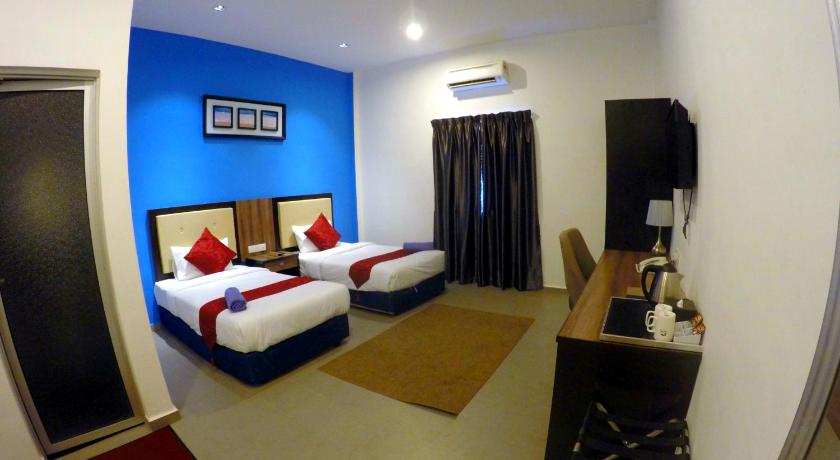 a hotel room with two beds and a mirror, Royal Agate Beach Resort in Langkawi