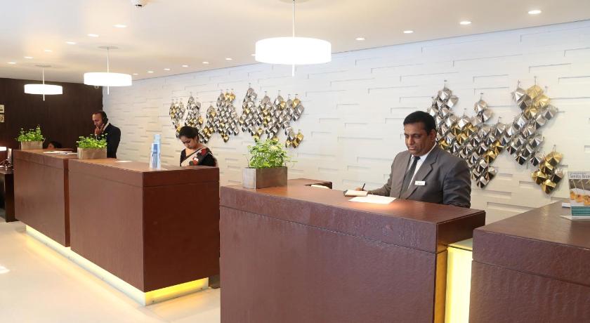 a man sitting at a table in front of a bar, Ramada by Wyndham Colombo in Colombo