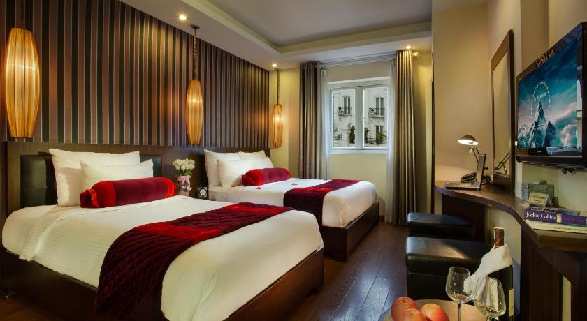 a hotel room with two beds and two lamps, Golden Art Hotel in Hanoi
