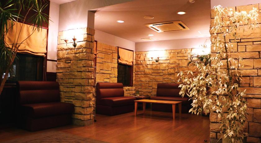 a living room filled with furniture and a fire place, Nasushiobara Station Hotel in Nasushiobara