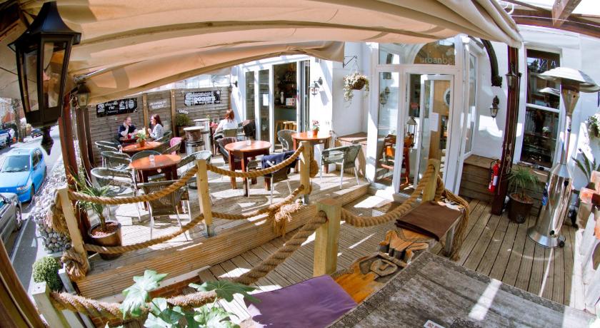 a living room filled with lots of furniture and umbrellas, Urban Beach Hotel in Bournemouth