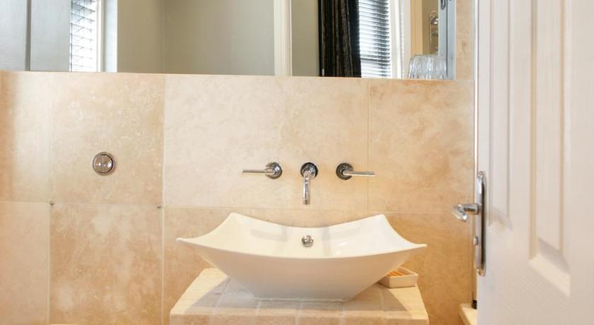 a white toilet sitting next to a sink in a bathroom, Urban Beach Hotel in Bournemouth