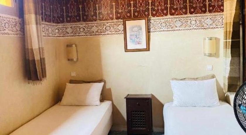Image of Basic Triple Room with Shared Bathroom 0