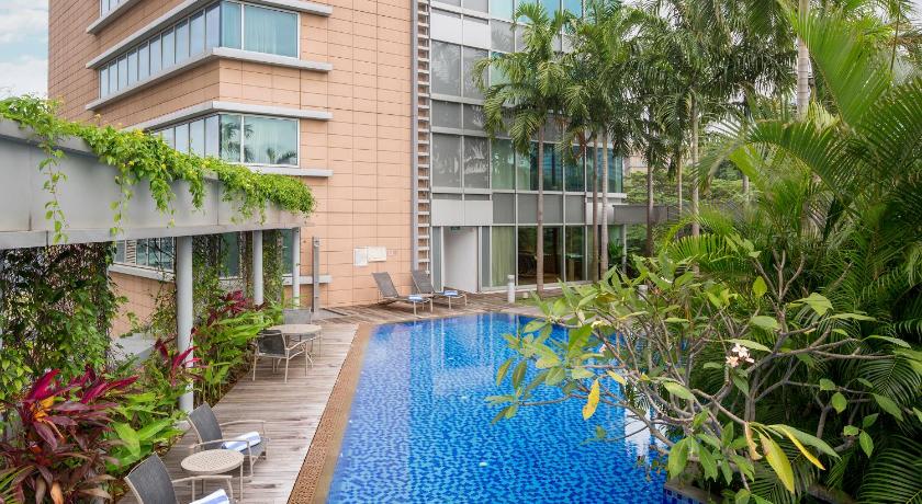 a large building with a pool of water in front of it, Park Avenue Rochester Hotel (SG Clean Certified) in Singapore