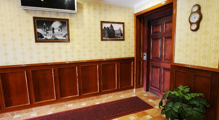 a room with a clock on the wall and a painting on the wall, Hotel Barbakan in Pecs