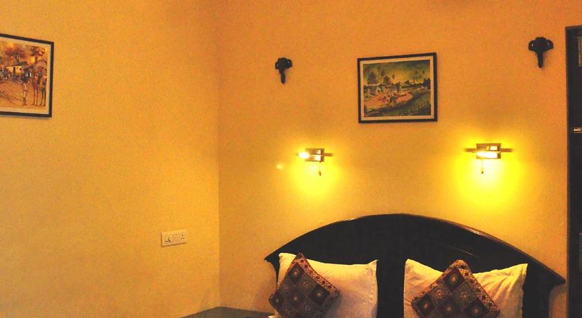 a bedroom with a bed and a dresser, Sajhome in Kochi