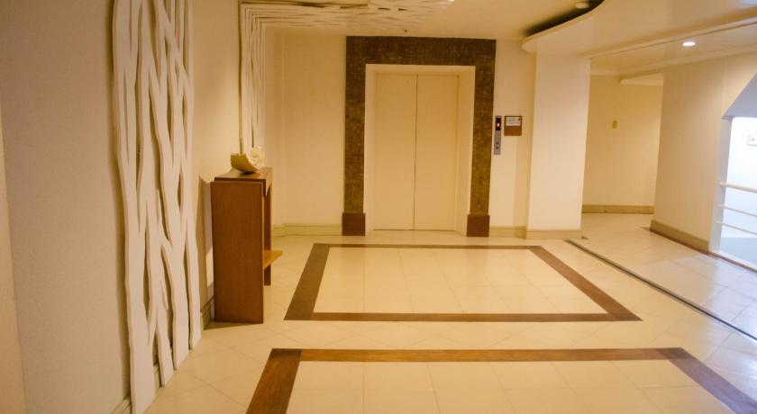 a hallway with a door leading into a room, Hotel Tavern Surigao in Surigao City