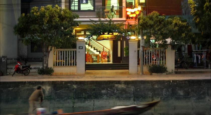 a large building with a clock on the front of it, Dong Nguyen Homestay Riverside in Hoi An