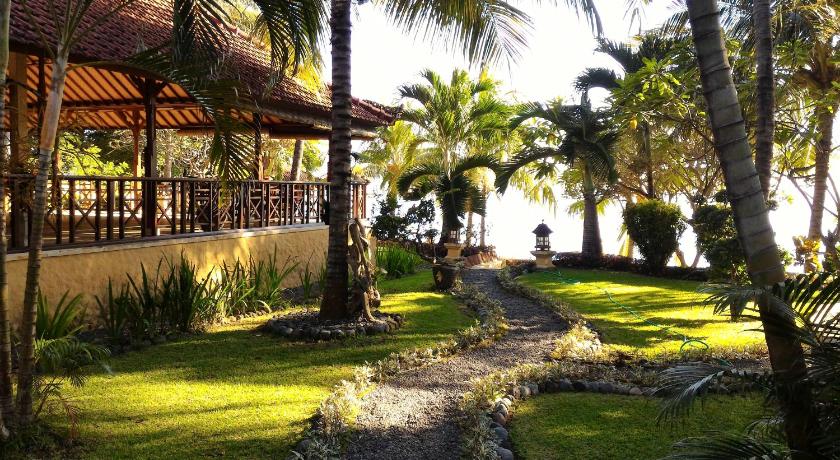 a scenic view of a beach with palm trees and palm trees, Teluk Indah Beach & Pool Villa in Bali
