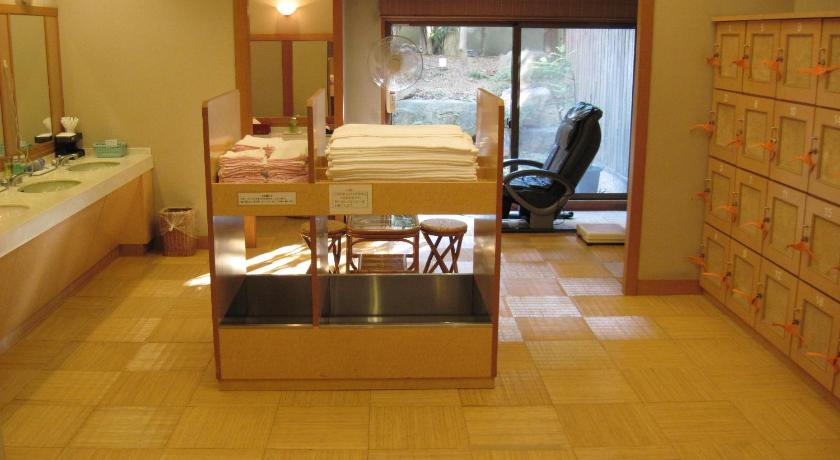 a hotel room with a bed, chair and a mirror, Kasuga Hotel in Nara