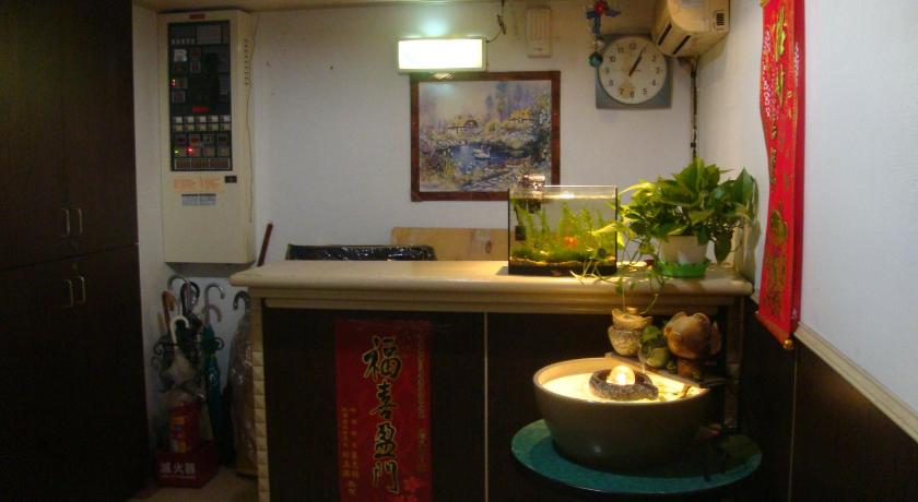a kitchen with a sink, counter, and a vase of flowers, San Ho Hotel in Taoyuan
