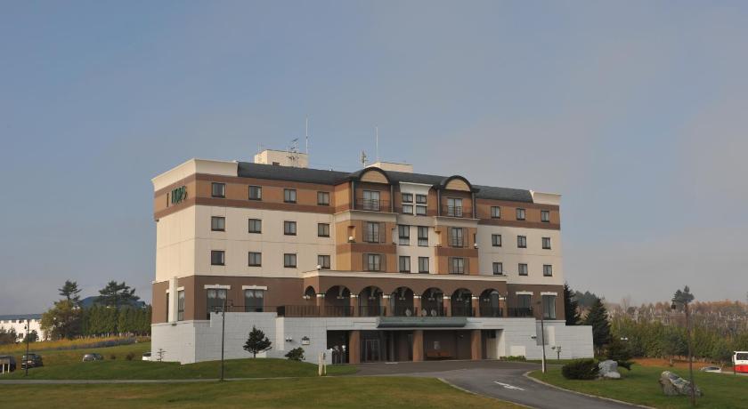 a large building with a large clock on the side of it, Furano Hops Hotel in Furano