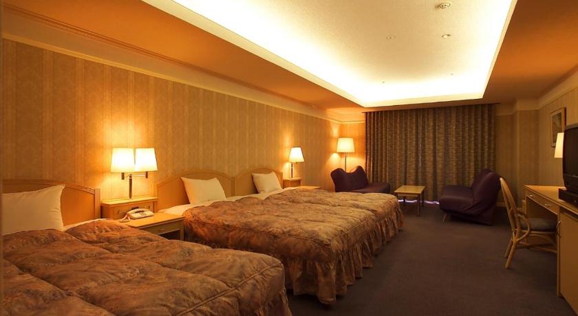 a hotel room with two beds and two lamps, Hotel Sekia in Kumamoto