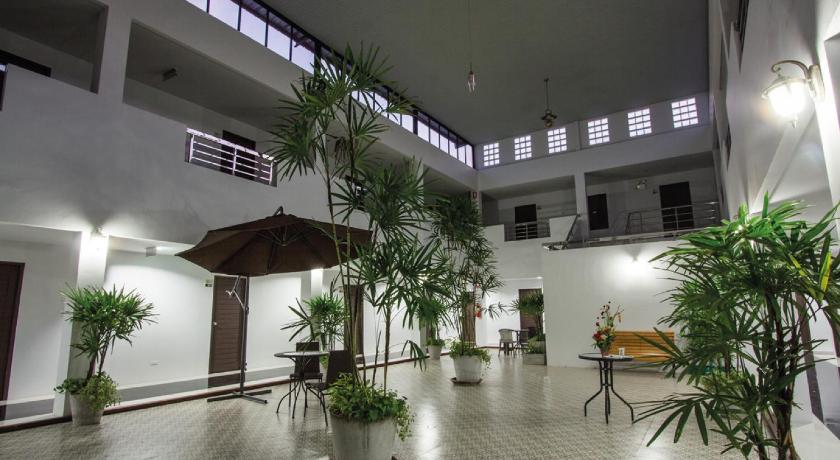 a large room with a large umbrella on the floor, Maison de Cheer in Trang